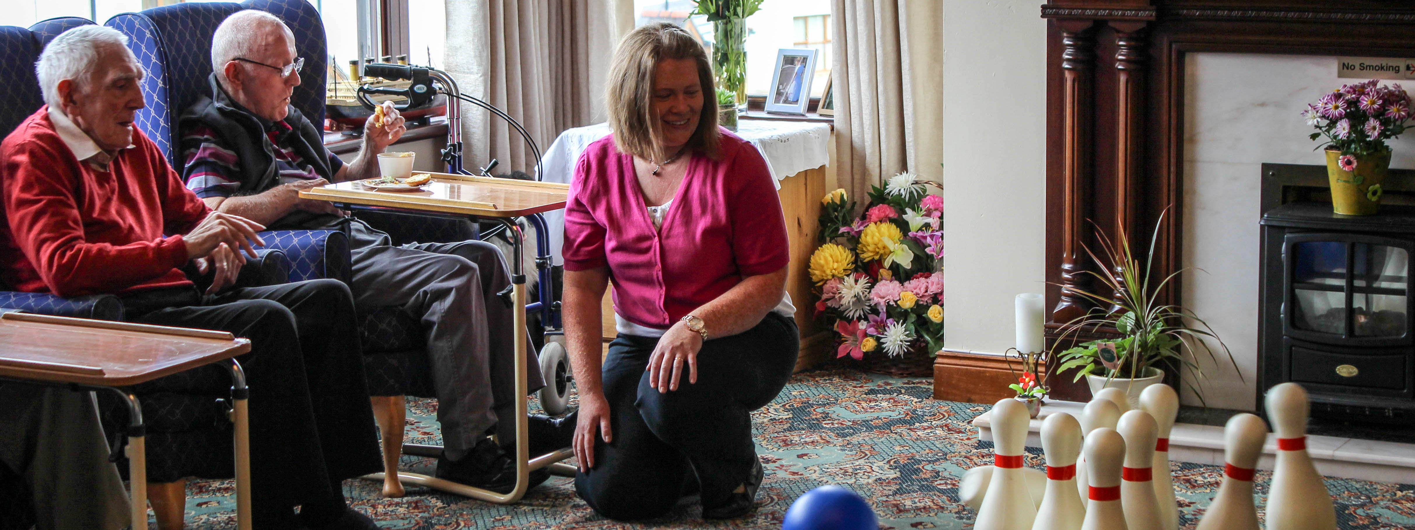 Residents enjoying a game of carpet bowls.